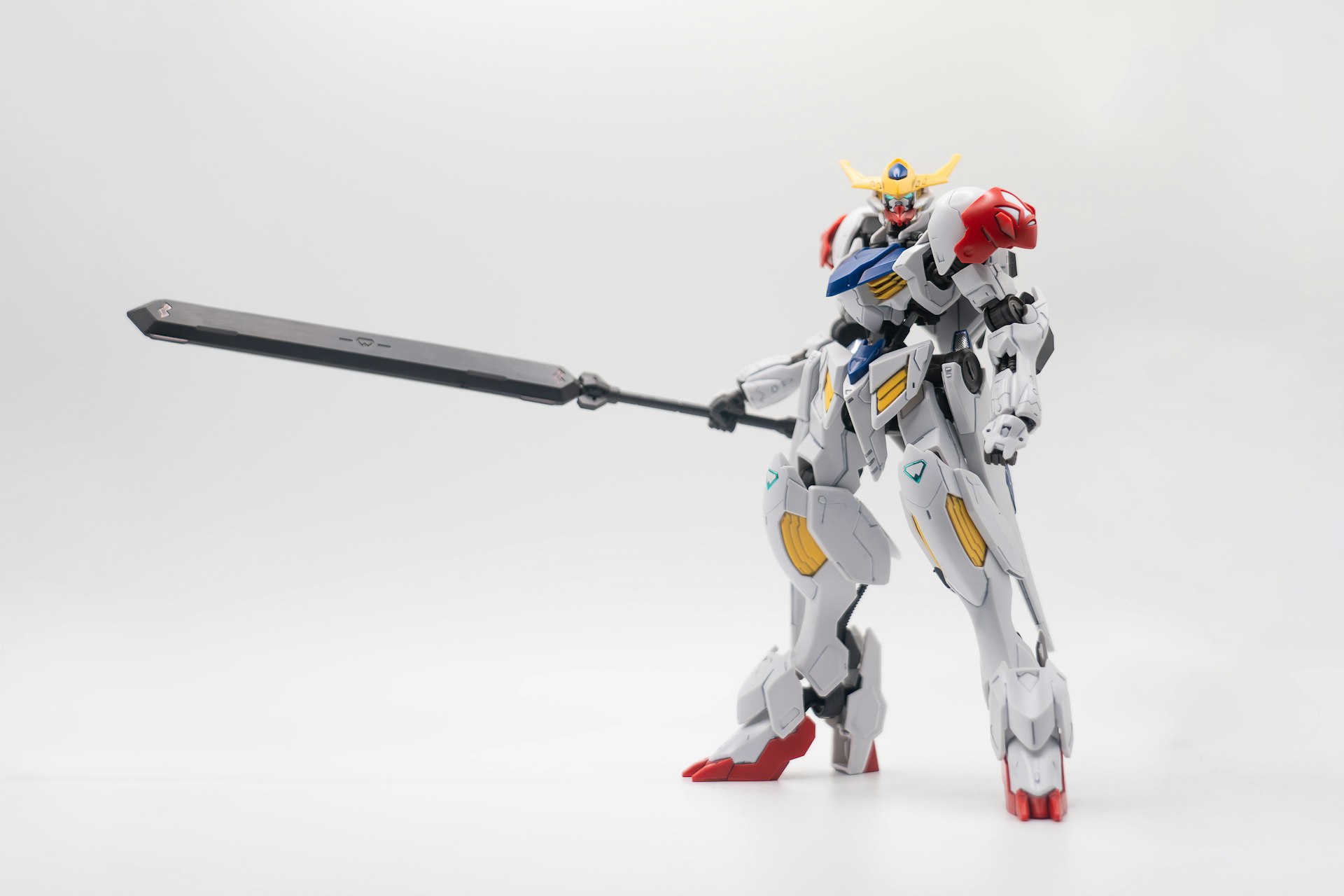 a robot that is holding a sword on a white background