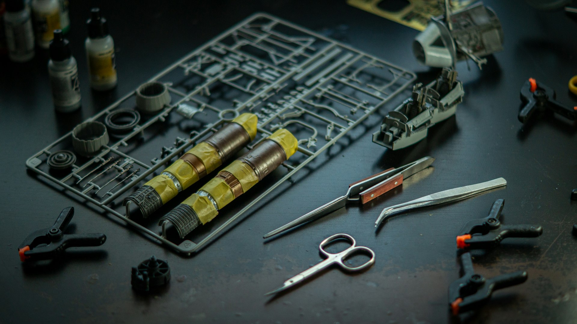 tools on a table next to a sprue from a model kit