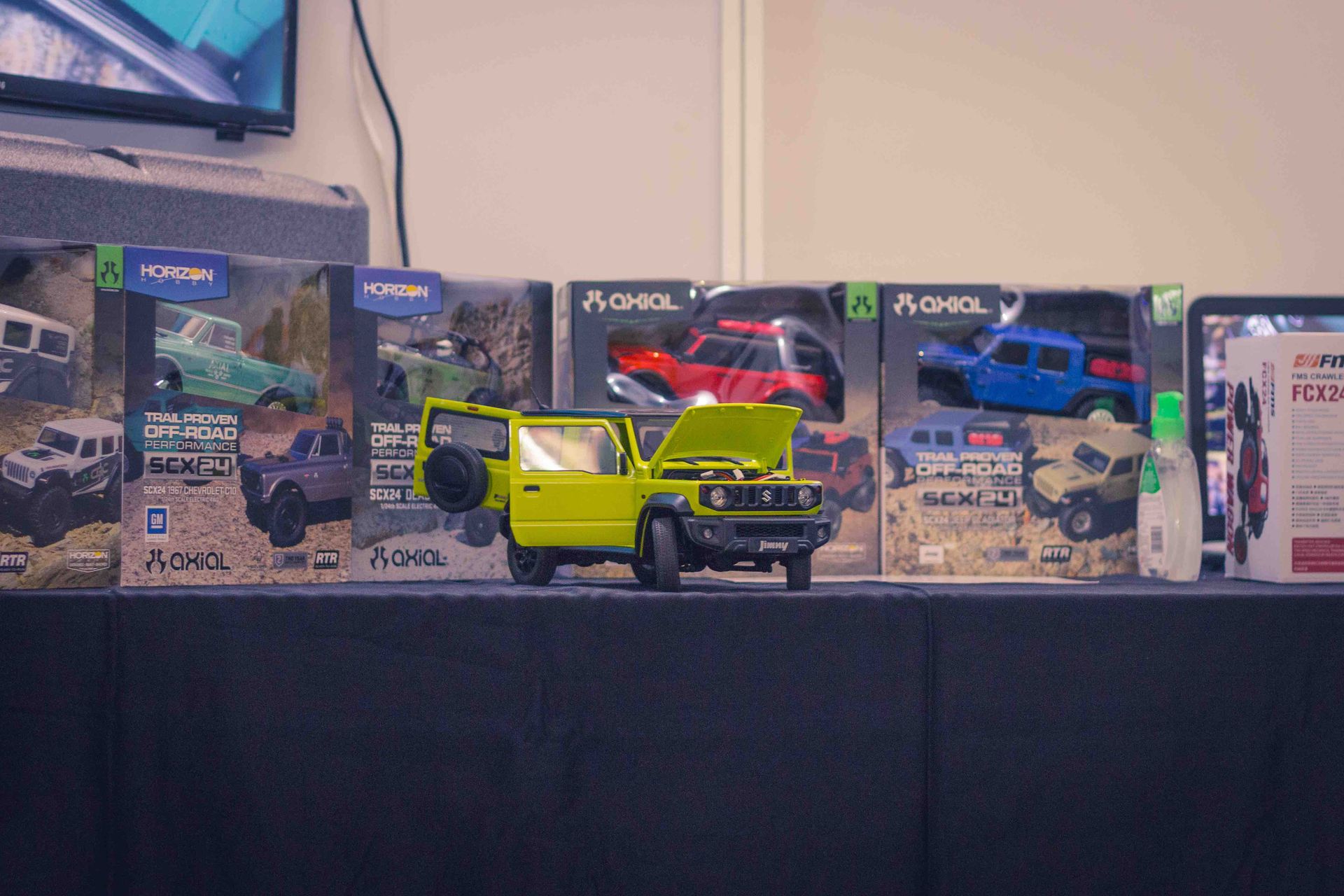 1/12 Suzuki Jimny Scale Model RC Car and Axial SCX24 range of RC trucks in the background