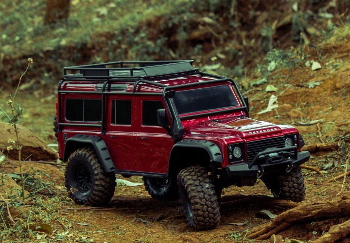 Red Land Rover Defender scale model RC out on the trails in Kenya